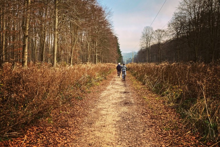 a person flying through the air while riding a bike down a dirt road