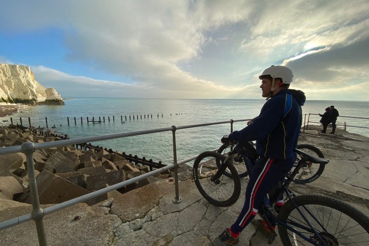 a person riding a bicycle on a beach