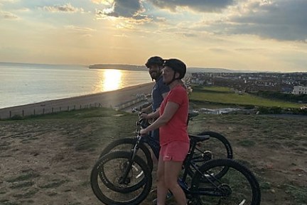 a person riding a bicycle on a beach