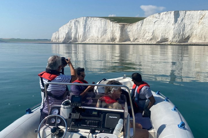 a group of people in a boat on a body of water