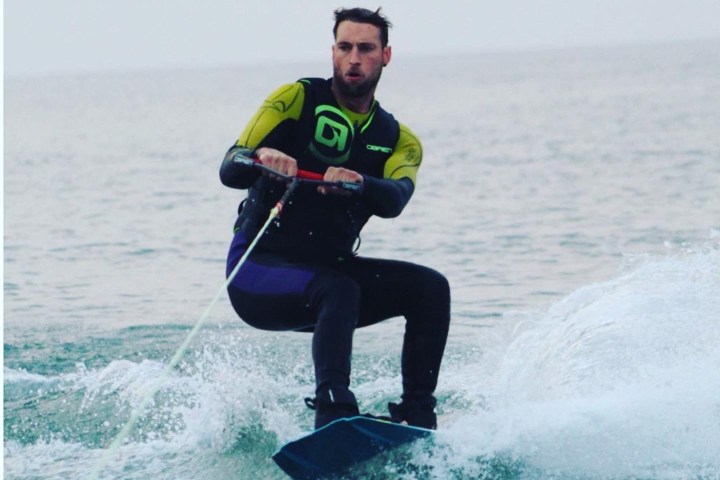 Dave Romney riding a wave on top of a body of water