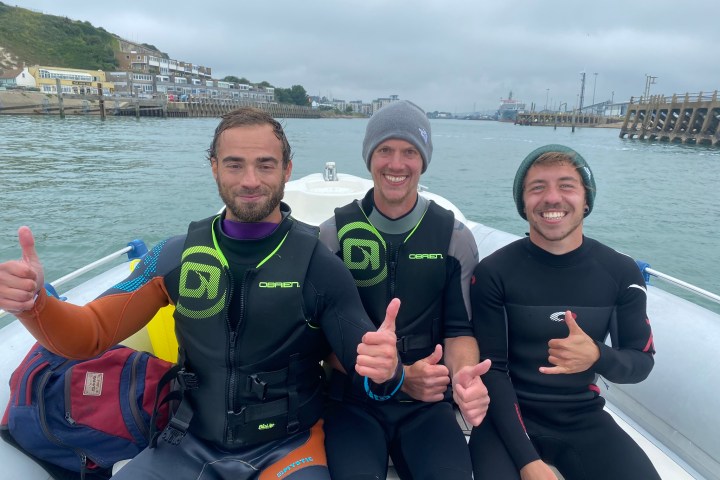 a group of people on a boat posing for the camera