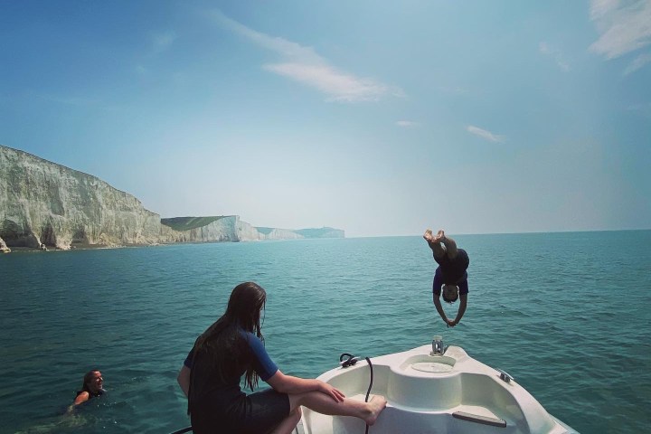 a group of people in a boat on a body of water