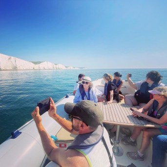 a group of people in a boat on a body of water
