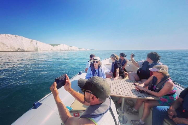 a group of people in a boat on a body of water