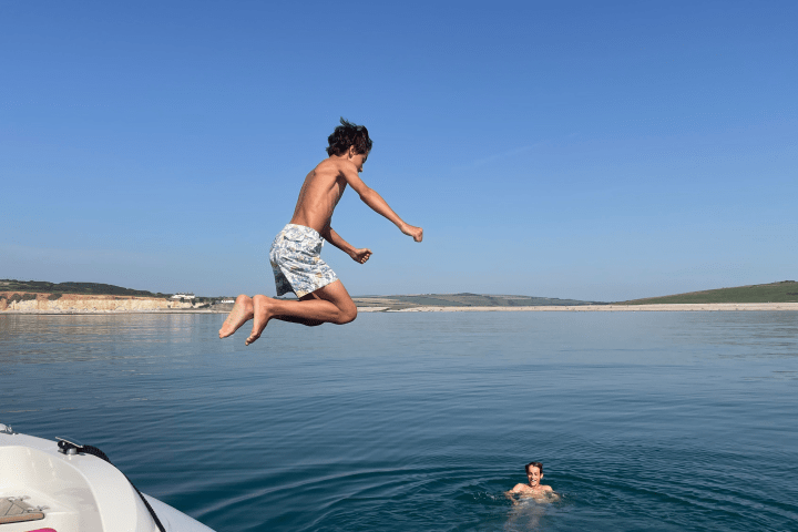 a man flying through the air over a body of water