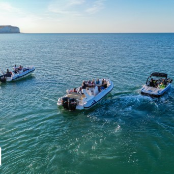 a group of people standing in front of a body of water