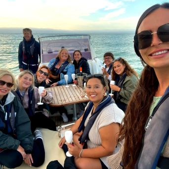 a group of people standing next to a body of water