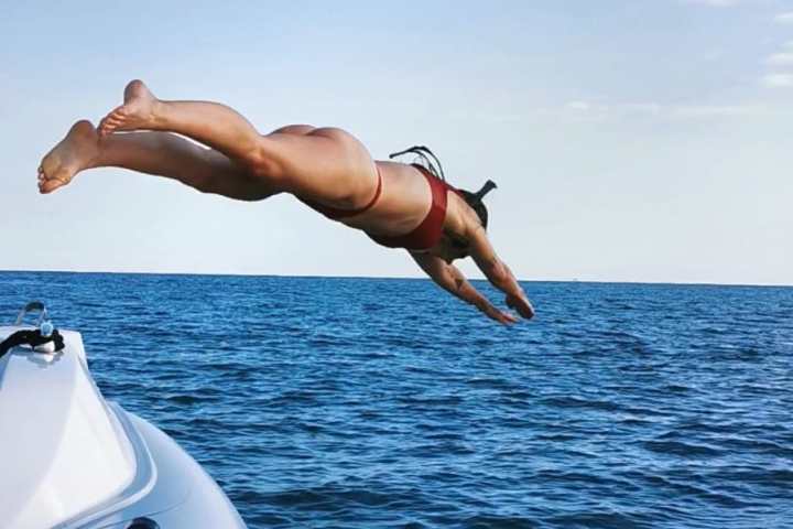 a group of people sitting in front of a body of water
