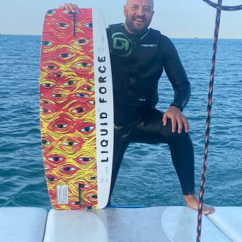 a man standing next to a body of water