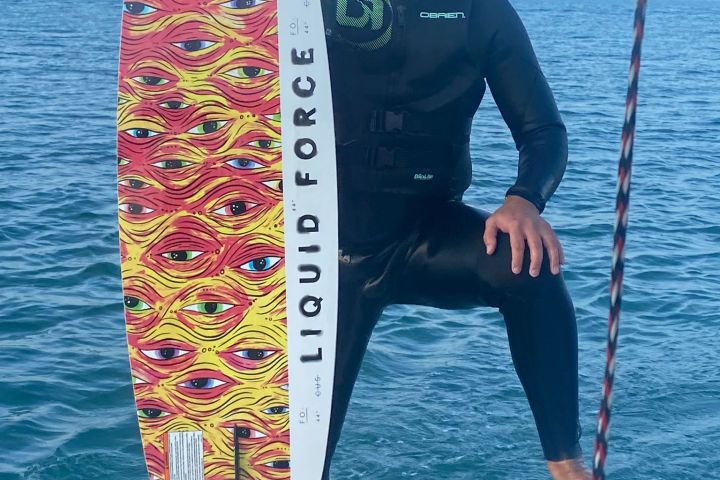 a man standing next to a body of water