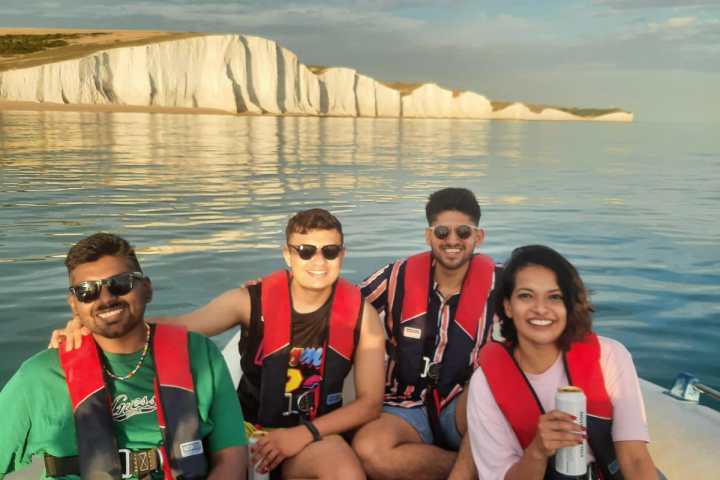 a group of people sitting in a boat on a body of water