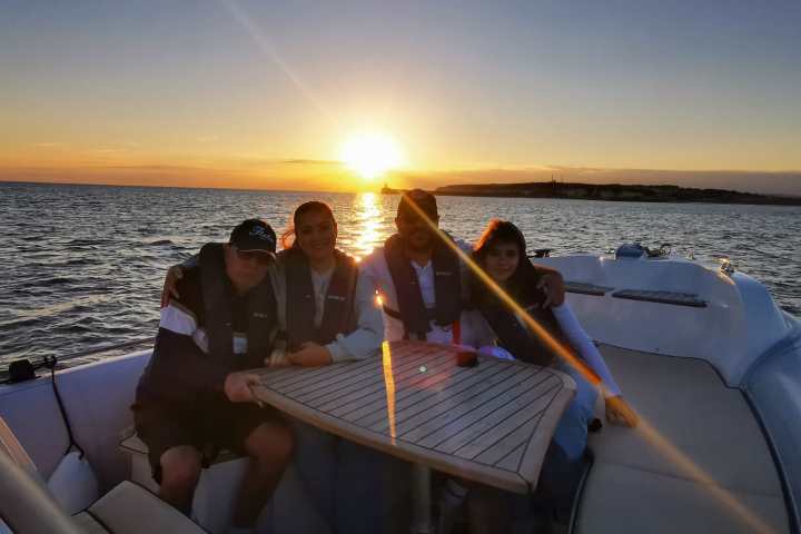 a person sitting on a beach near a body of water