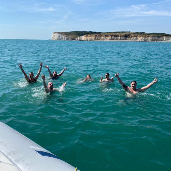a group of people swimming in a body of water