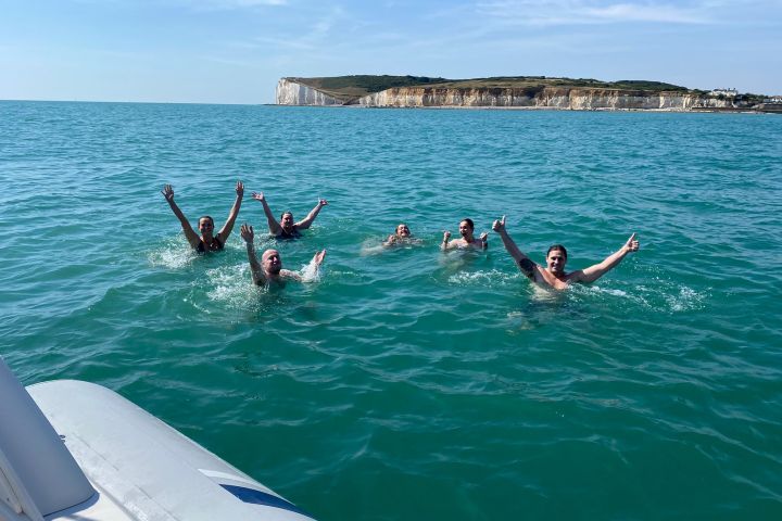 a group of people swimming in a body of water