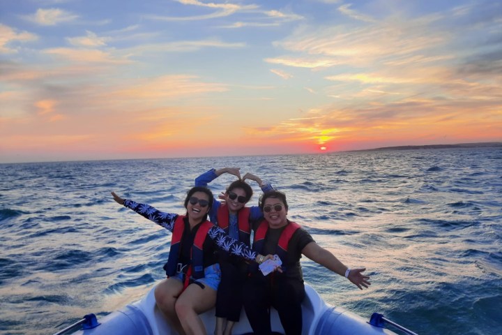 a man and a woman standing next to a body of water
