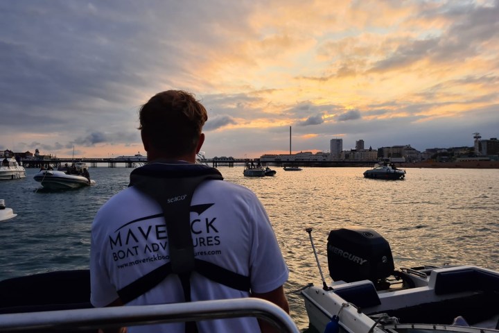 a man sitting in a boat on a body of water