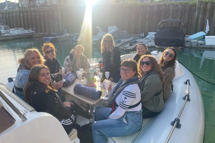 a group of people on a boat posing for the camera