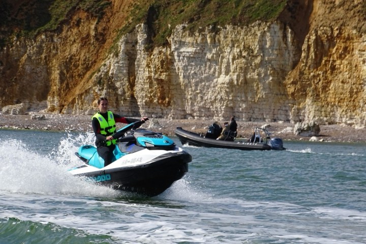 a person riding on the back of a boat in the water