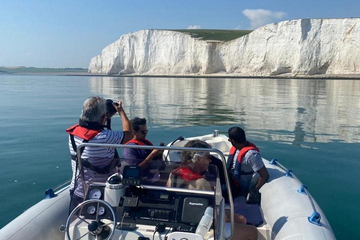 a man sitting in a boat on a body of water