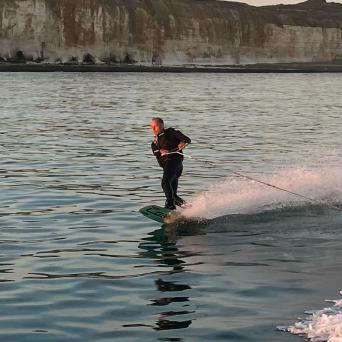a person riding a surf board on a body of water