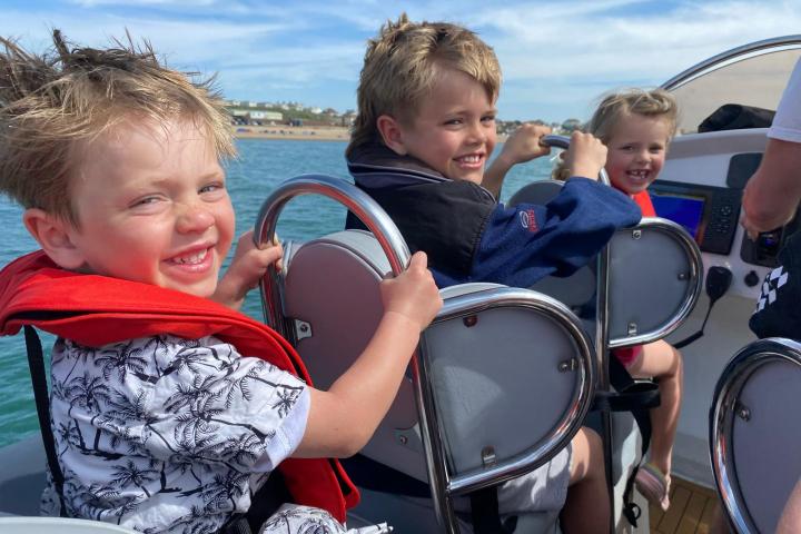 a little boy sitting on a boat