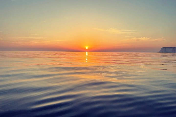 a sunset over a body of water